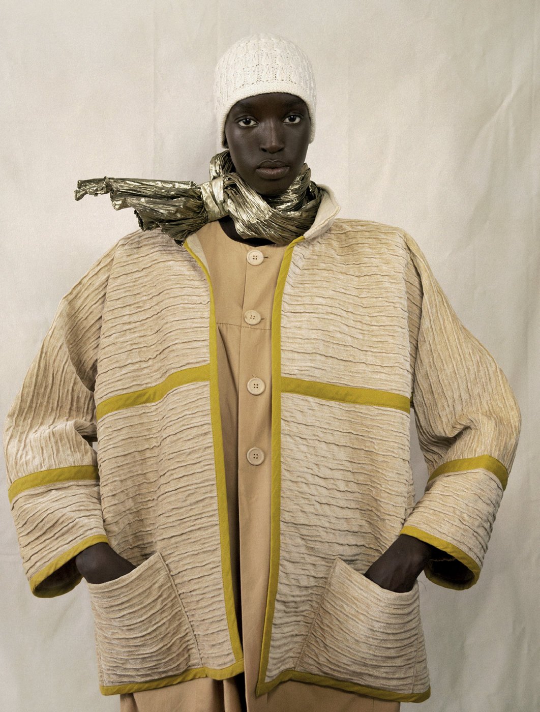 person in yellow jacket with their hands in the pockets of the jacket