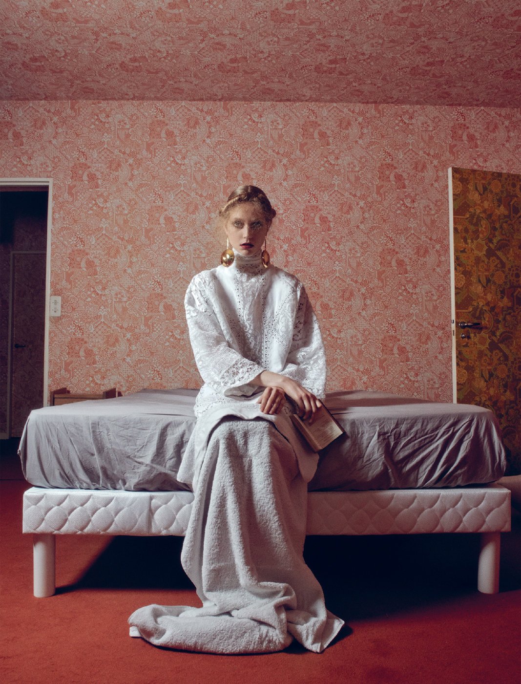 woman sits on the edge of bed