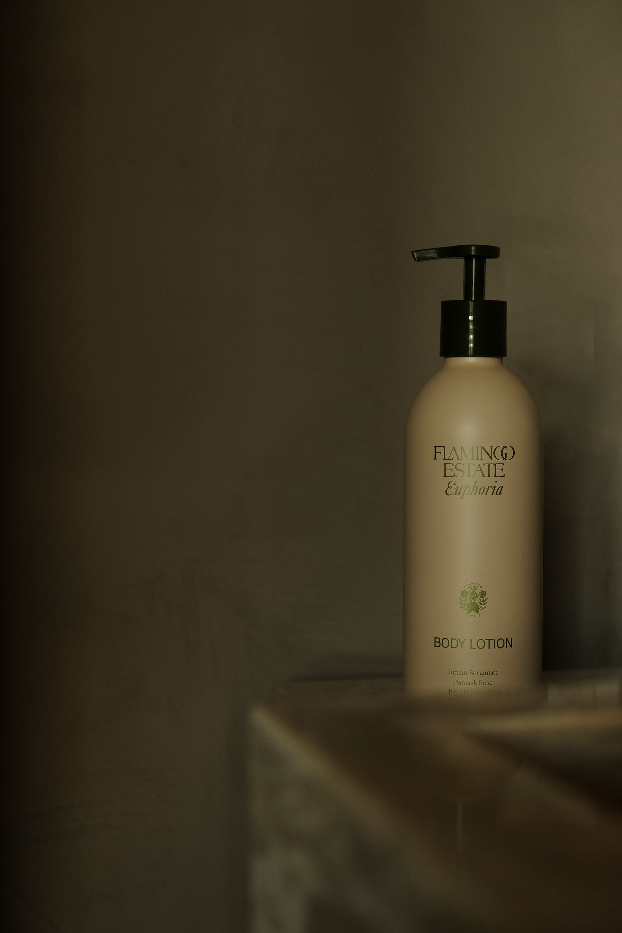 cream coloured bottle with pump dispenser sits on the edge of a sink