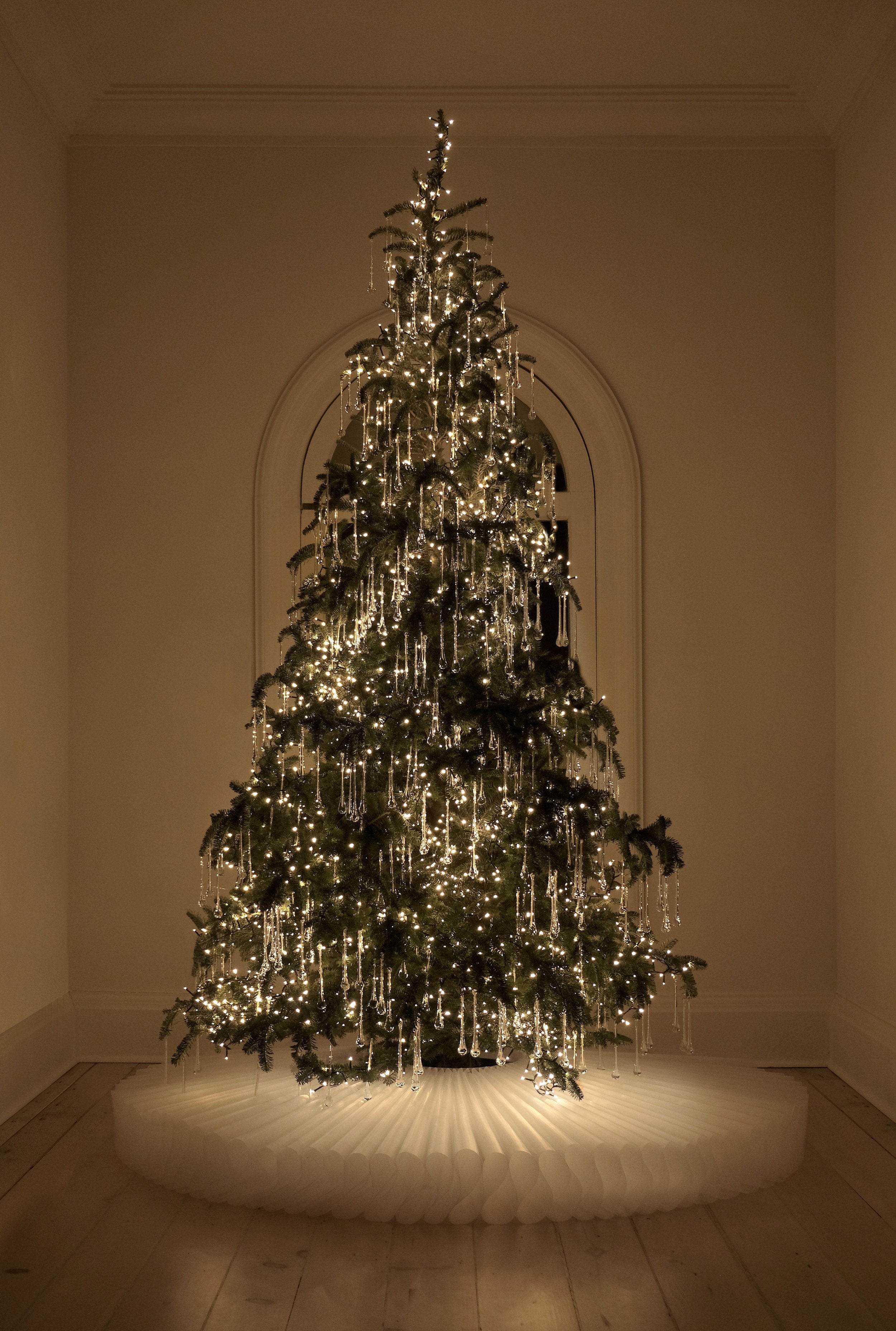 Tear drop shaped, organically hand blown glass icicles on a lit up christmas tree