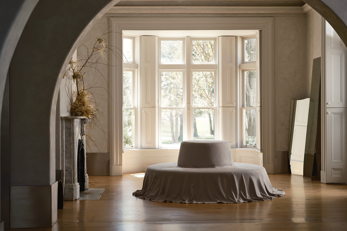 circular couch sits in the middle of large bright room