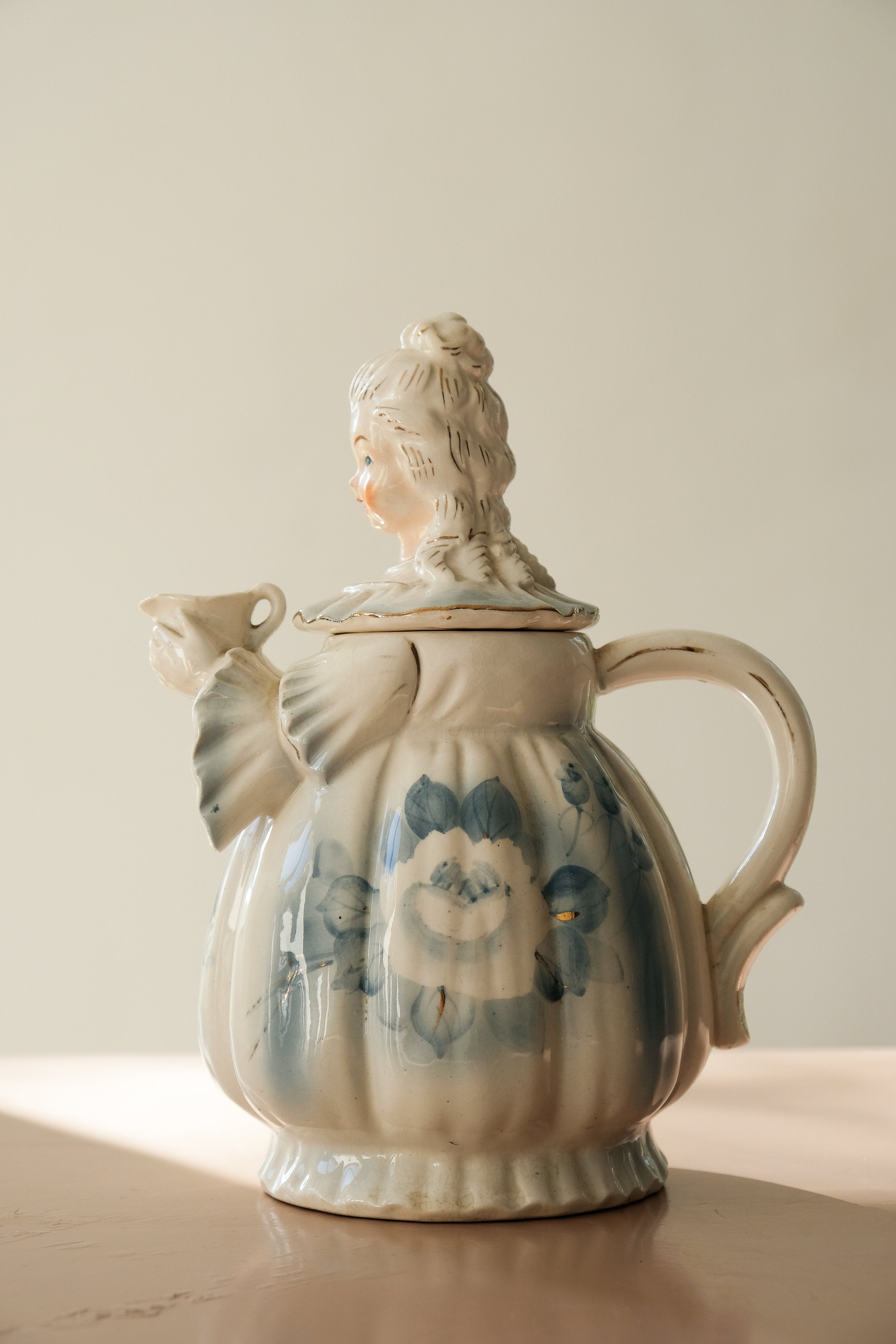 a teapot shaped like a woman