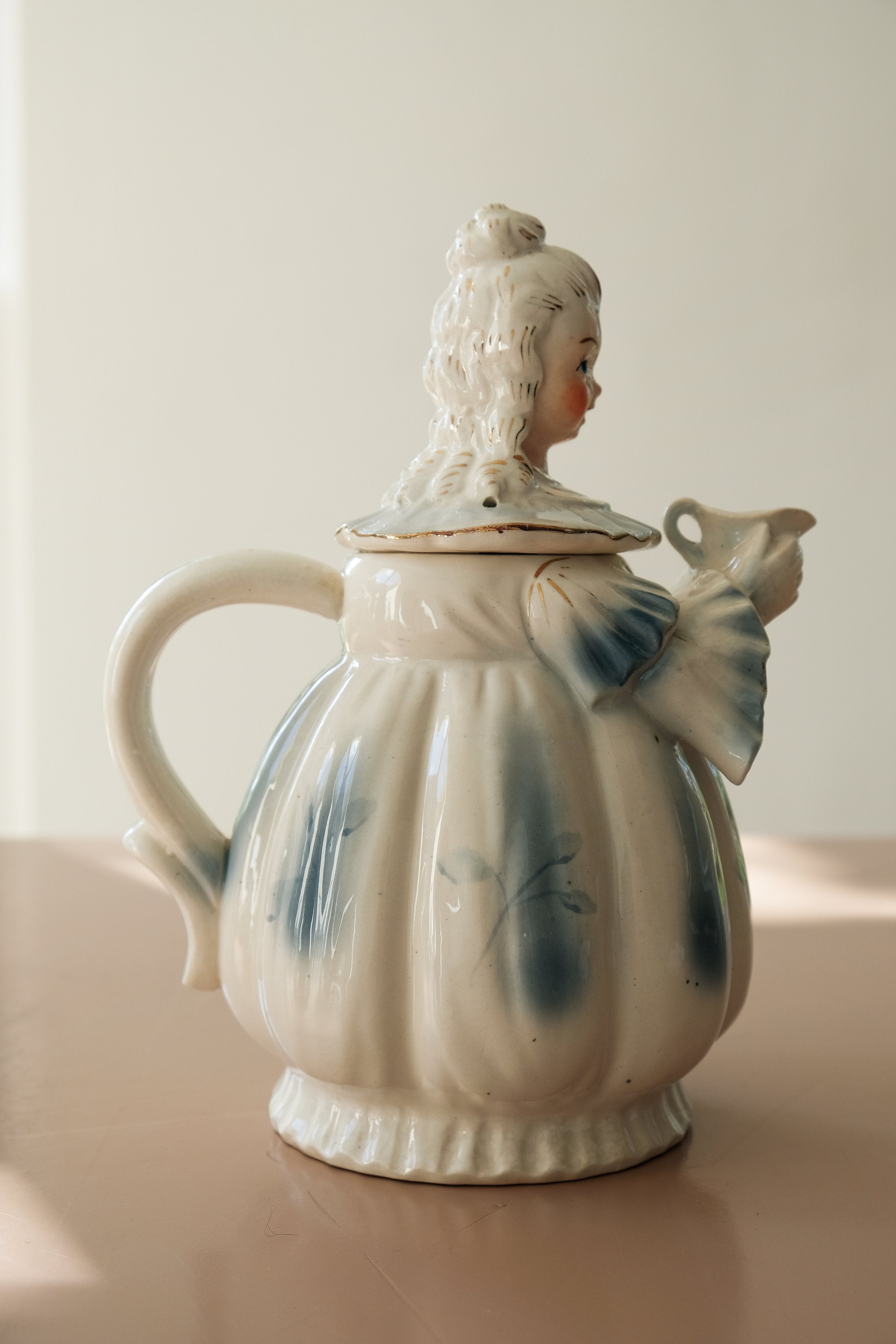 a teapot shaped like a woman