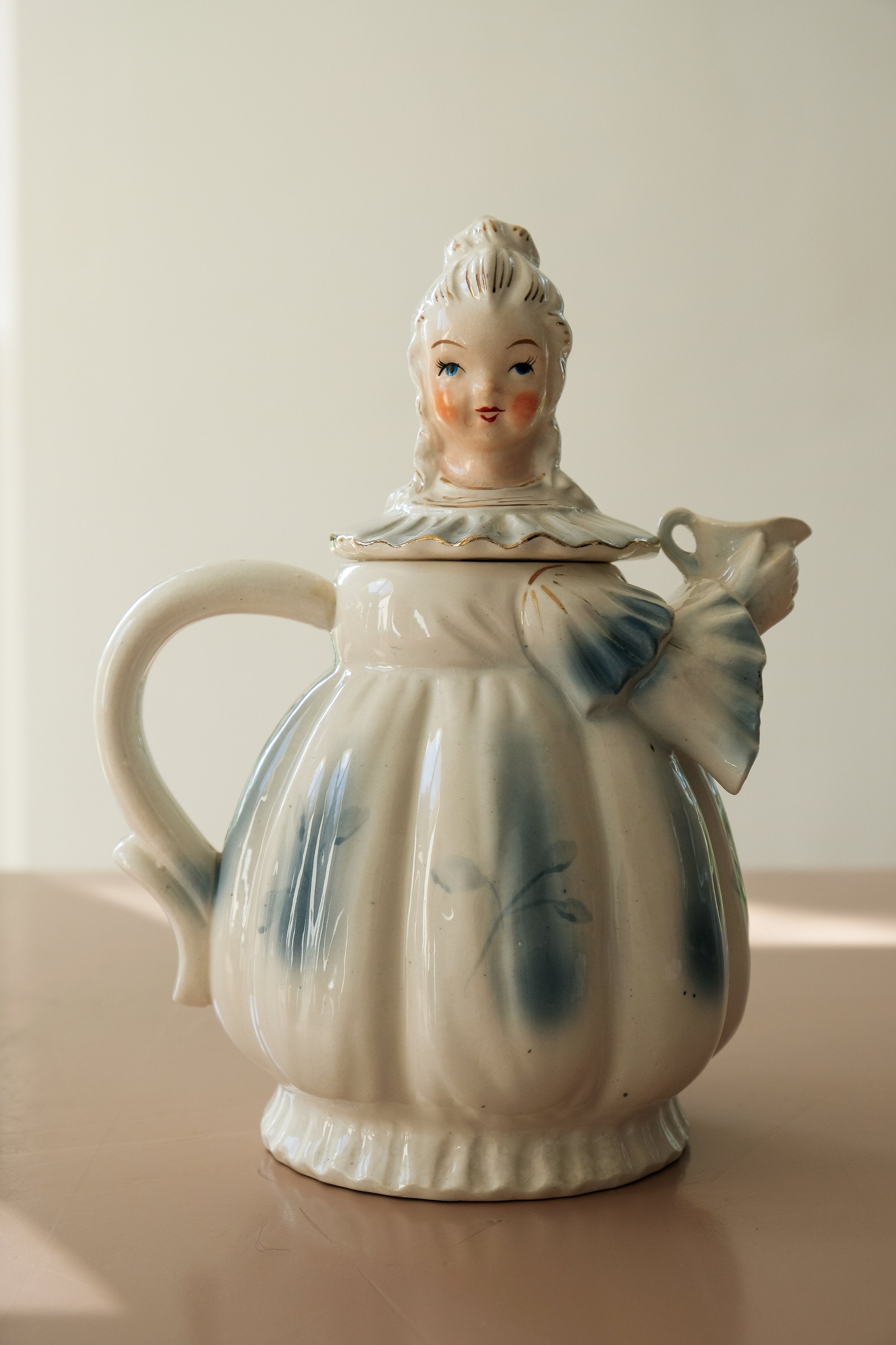 a teapot shaped like a woman