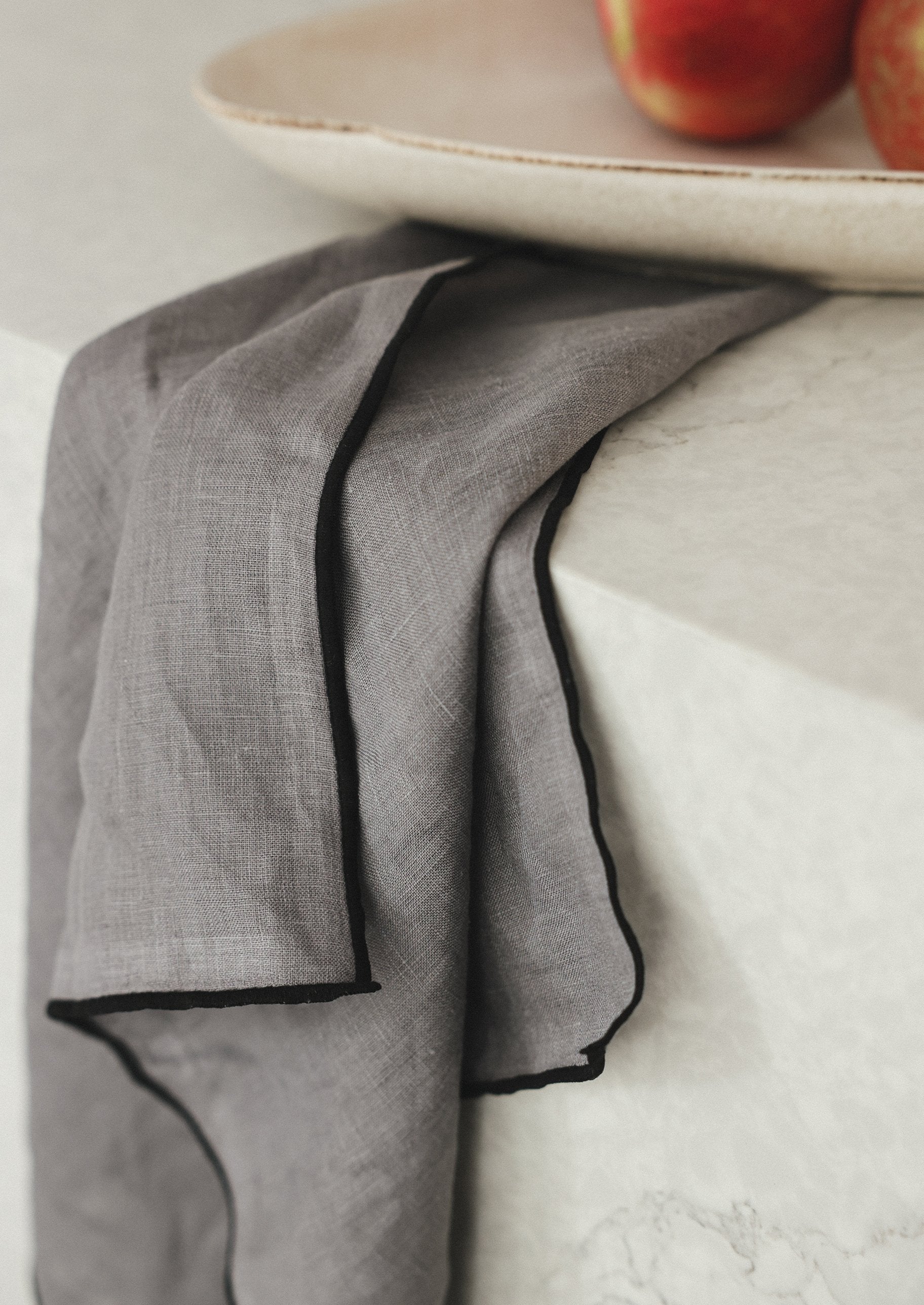 grey linen napkins with black edge detailing