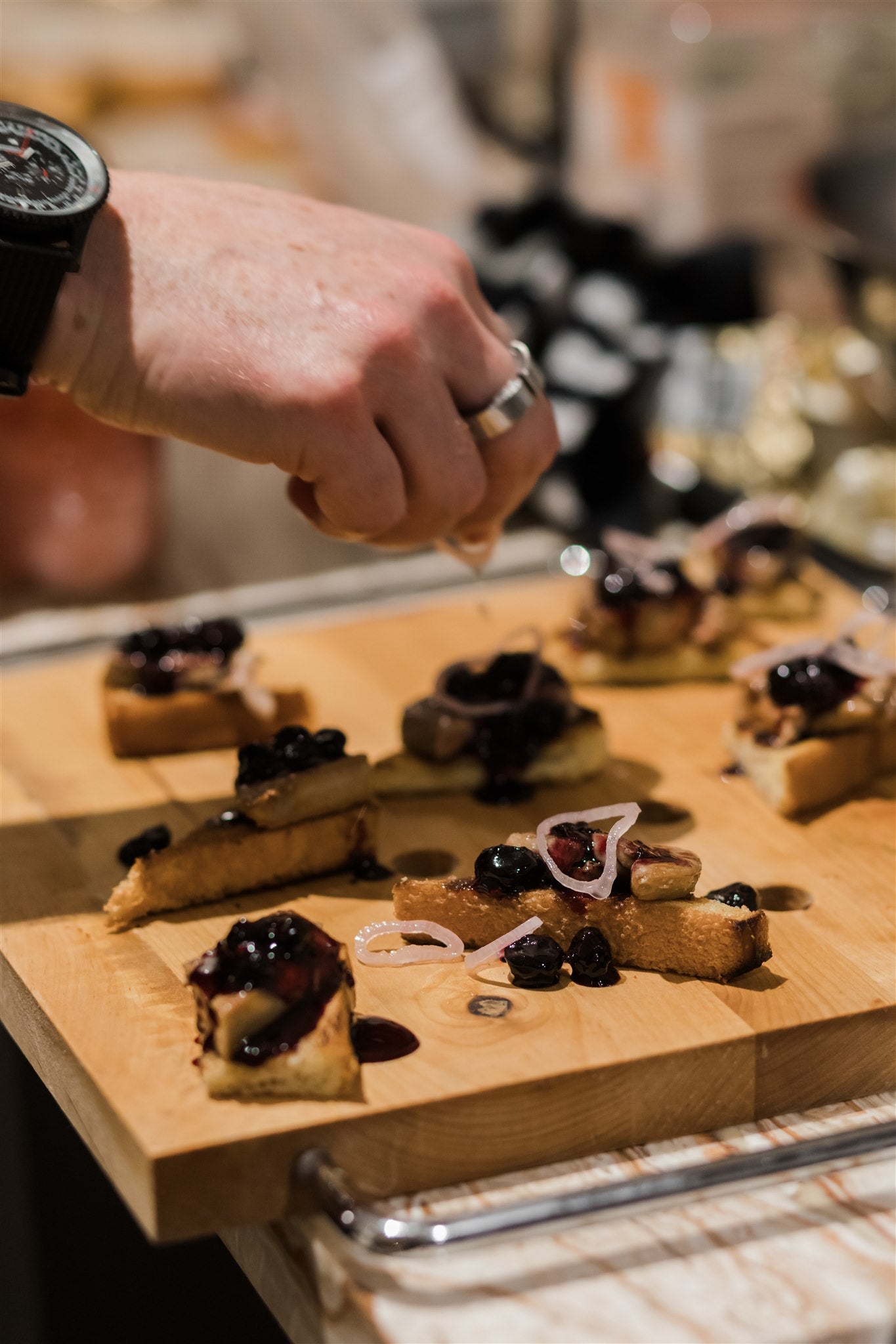 hand placing final touches on a dish