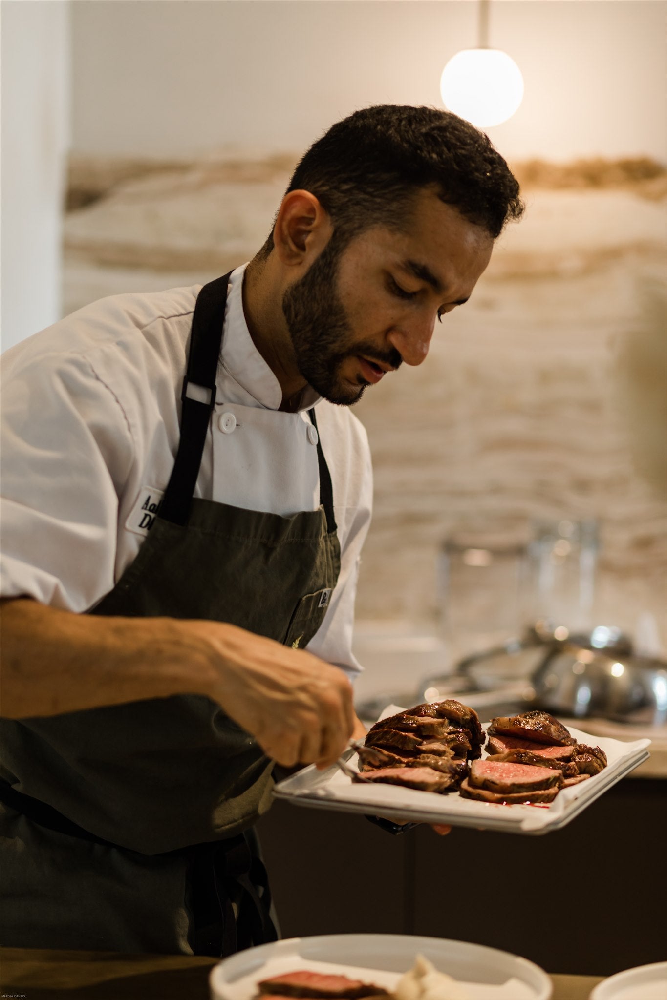 chef Aakash Dhall serving steak