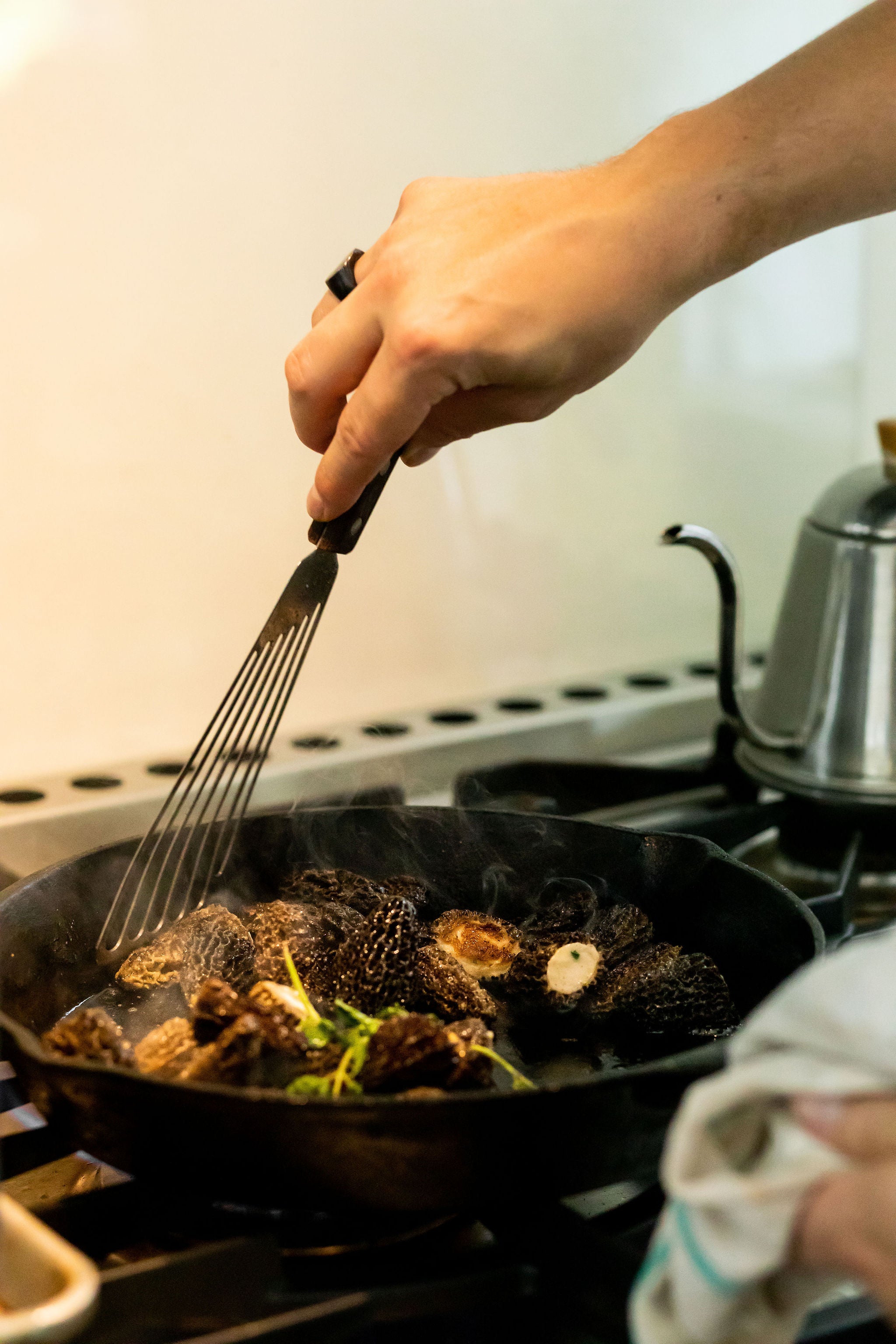 mushrooms searing in a cast iron pan