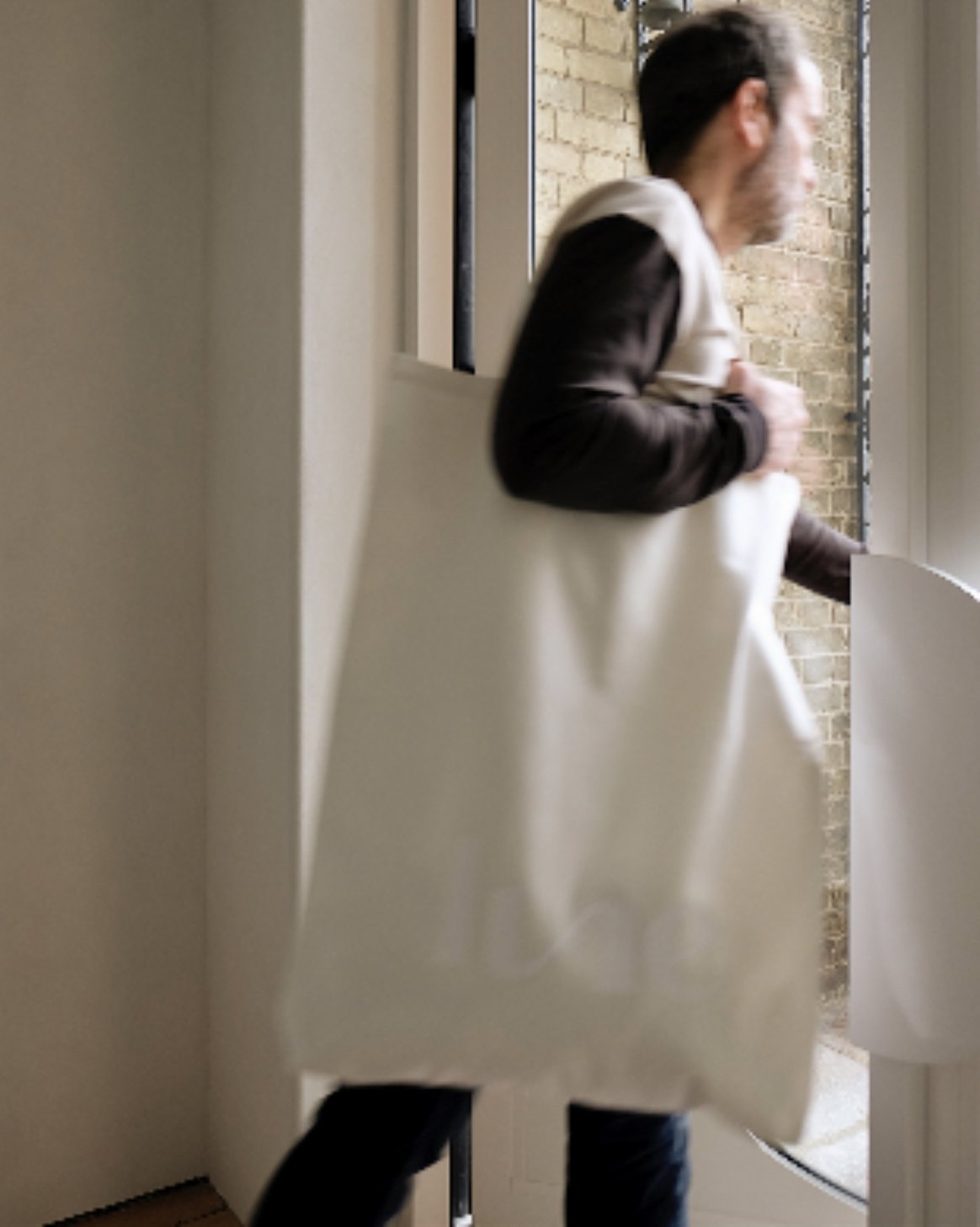 man holding oversized tote bag