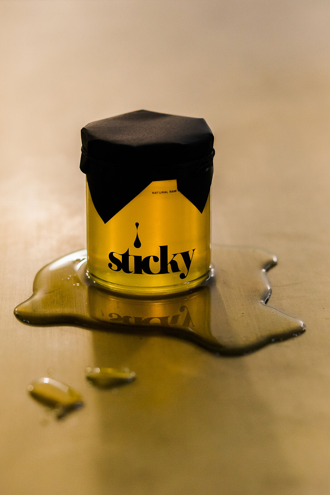 a jar of honey, labeled "sticky"