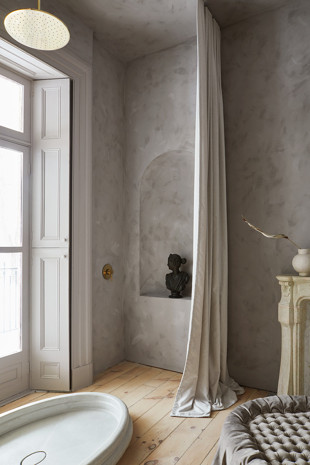 rain shower in front of french doors, warm grey plaster walls, white marble fireplace mantle 