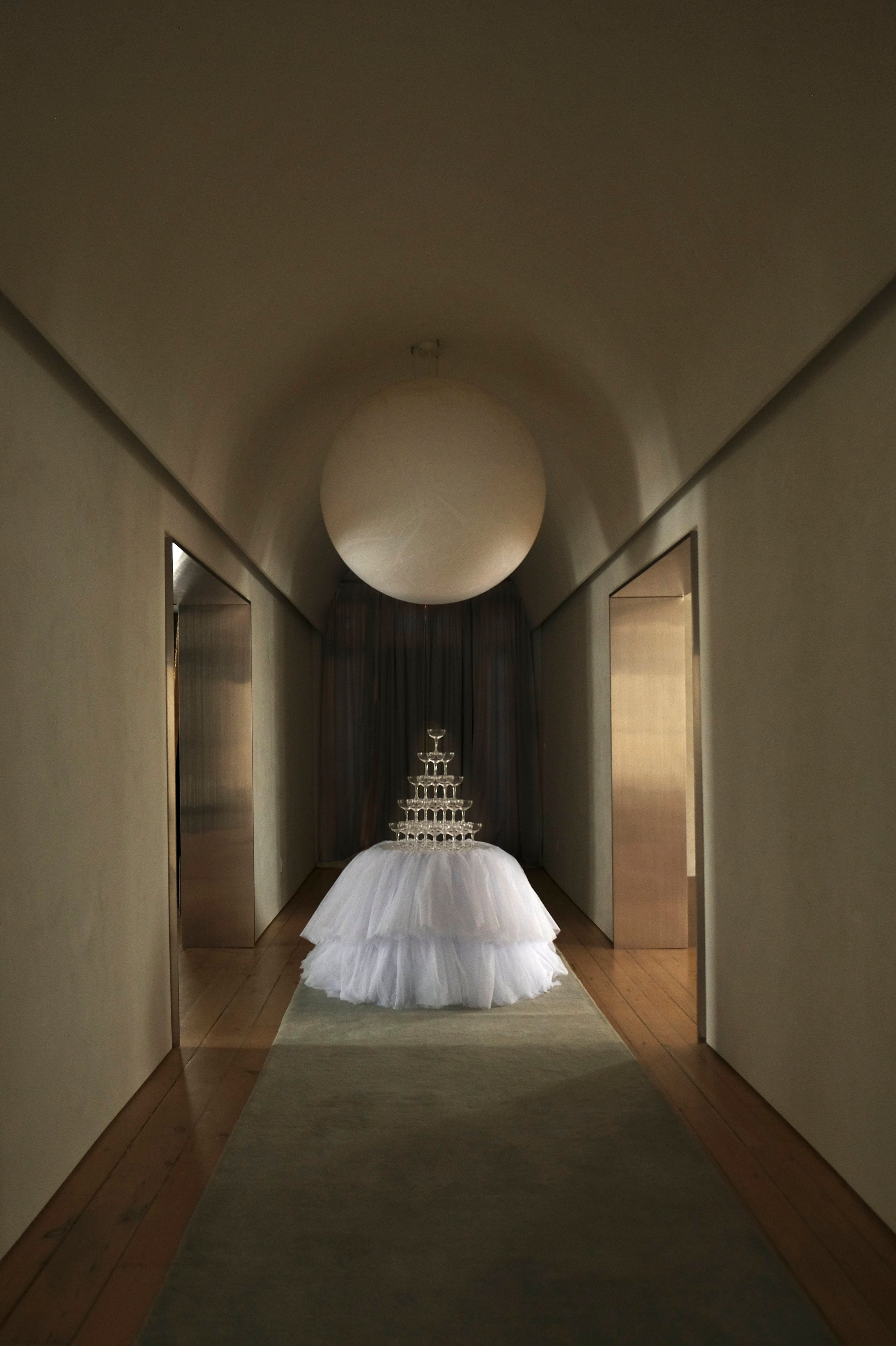 tablecloth with tulle details under large moon pendant