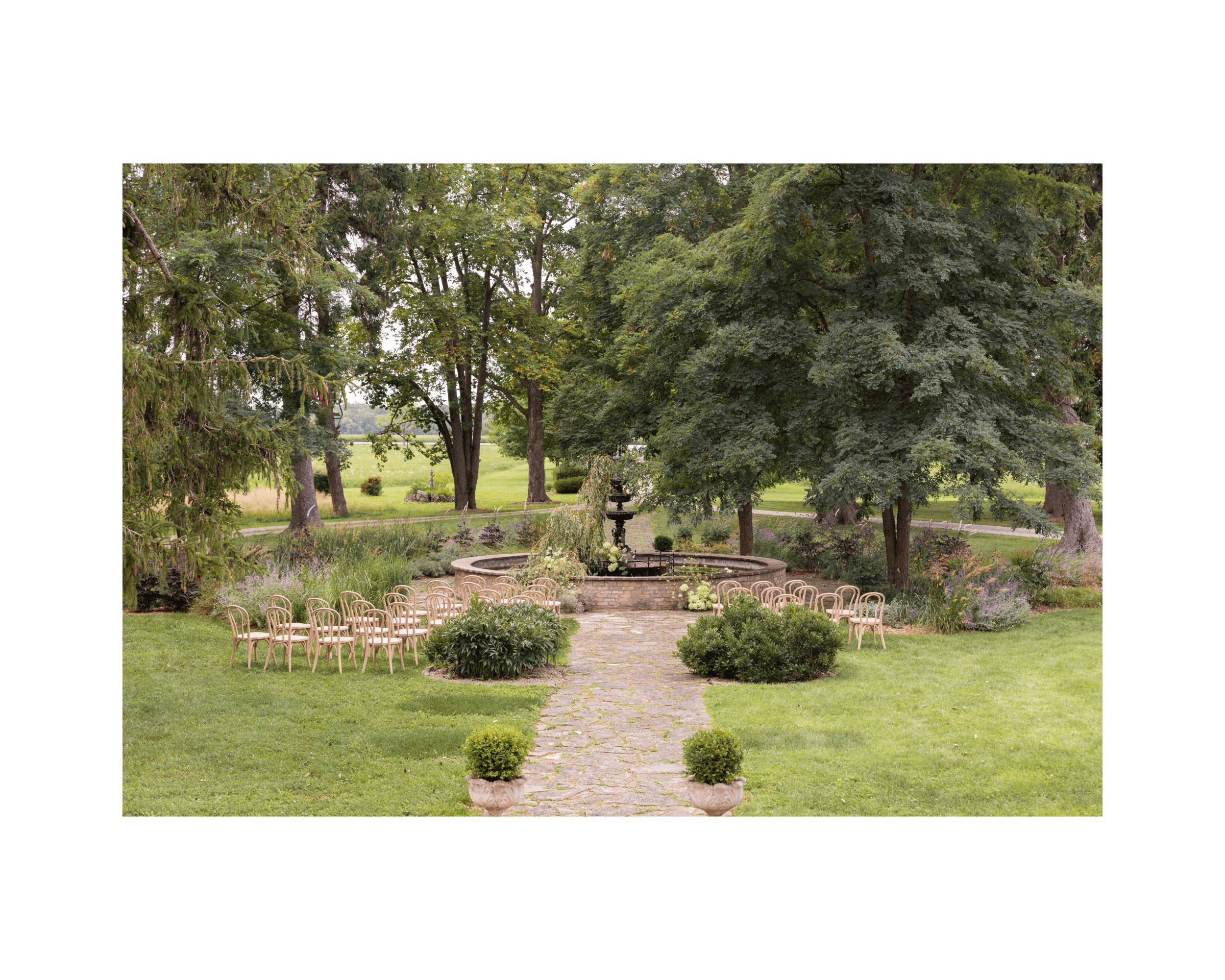 chairs arranged for wedding ceremony in front of historic fountain